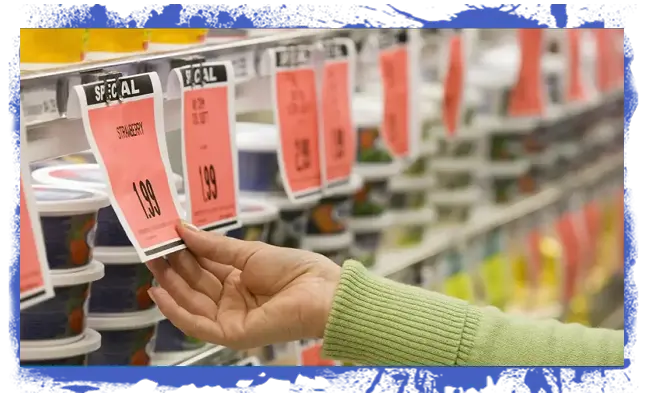Hand reaching for a red price tag labeled "Special" in a grocery store dairy aisle with stacked containers of food in the background.